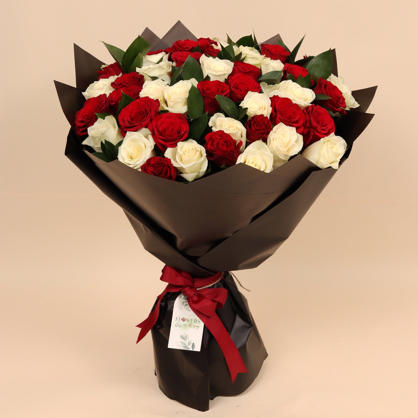 Classic Love is a luxurious bouquet of 50 fresh roses in red and white, beautifully arranged to reflect both passion and purity. Wrapped in elegant black paper, the contrast enhances the bold colors and gives it a timeless, sophisticated look.
Perfect for romantic gestures, anniversaries, or heartfelt expressions of love and appreciation. Handcrafted with premium blooms and available for same-day delivery in Dubai.