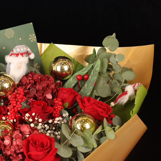 Golden Snowflake - close-up of red roses, gold baubles and mini Santas, Christmas bouquet Dubai