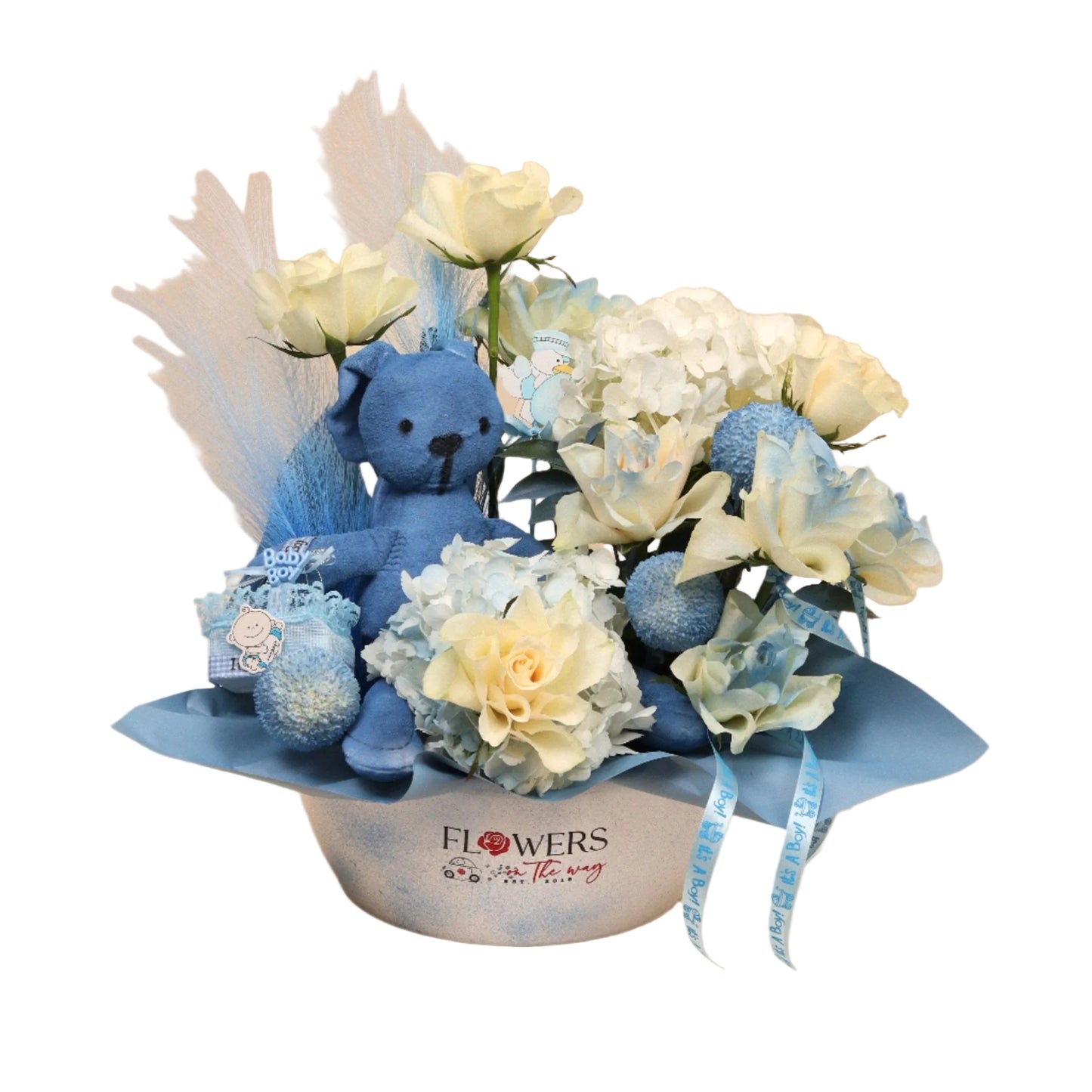 Little Whisper is a soft and elegant floral arrangement created to welcome a precious baby boy. Featuring white roses and blue blooms, it’s centered with a cute blue teddy bear for an extra sweet touch. Perfect as a newborn gift or baby shower decoration that radiates love and joy.
Crafted with fresh flowers and delivered with care – available for same-day delivery in Dubai.