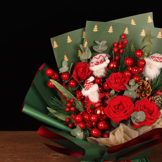 Holiday Cheer Bouquet - close-up of red roses, pine cones and mini Santas, Christmas bouquet Dubai