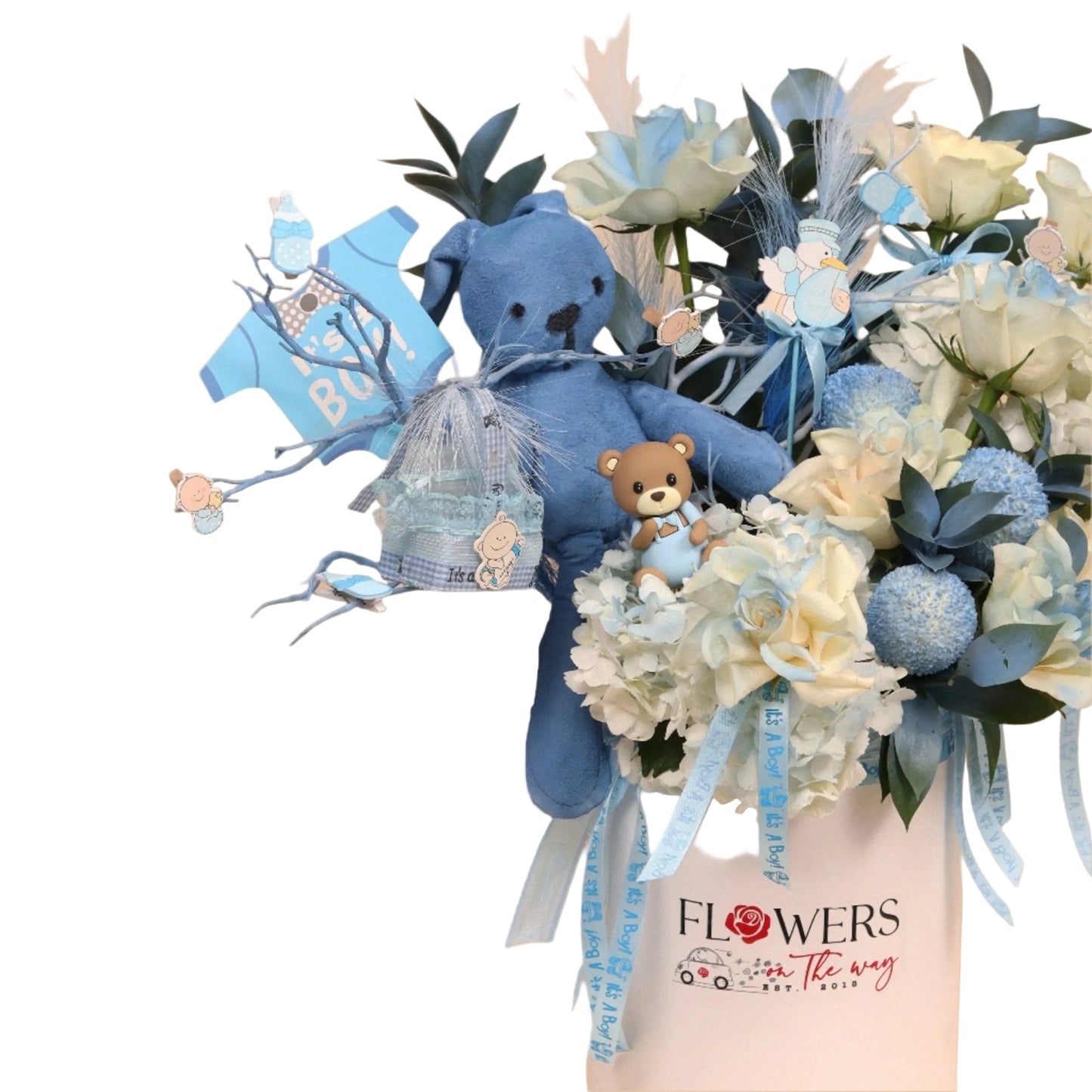 Little Heartbeat is a premium floral arrangement designed to welcome a precious baby boy with warmth and charm. It features fresh white roses, soft blue accents, blue pingpong flowers, and lush hydrangea blooms, creating a full and dreamy aesthetic. The arrangement is completed with a small blue teddy bear and adorable baby boy-themed accessories that add sweetness and personality.
Perfect as a newborn gift or a centerpiece for baby showers. Handcrafted with high-quality fresh flowers and available with sam
