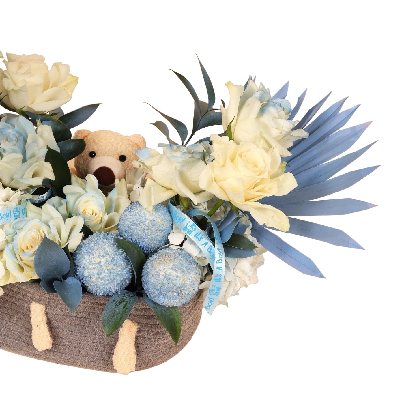 Little Prince Basket is a soft and elegant floral arrangement created to celebrate the arrival of a baby boy. Set in a shiny silver basket, it features a charming mix of white roses and blue flowers, beautifully accented with sweet baby boy-themed accessories.
At the center sits a small plush teddy bear, adding warmth and personality to the design.
Perfect as a newborn gift or a luxurious baby shower decoration. Handcrafted with fresh blooms and available for same-day delivery in Dubai.