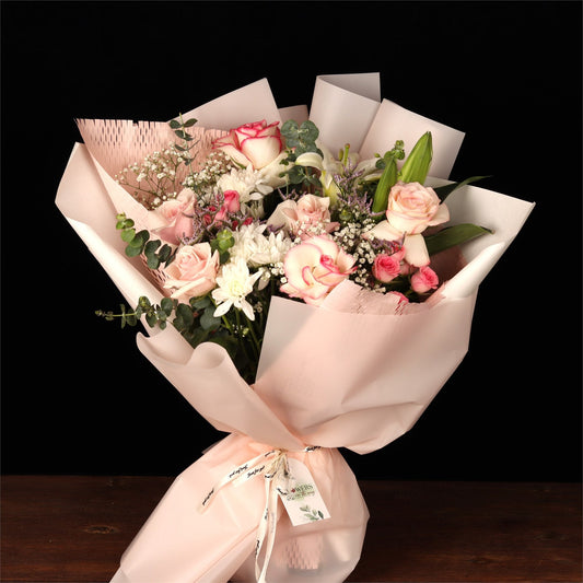 Blush roses and eucalyptus in pale wrap, the kind of bouquet that needs care in Dubai heat