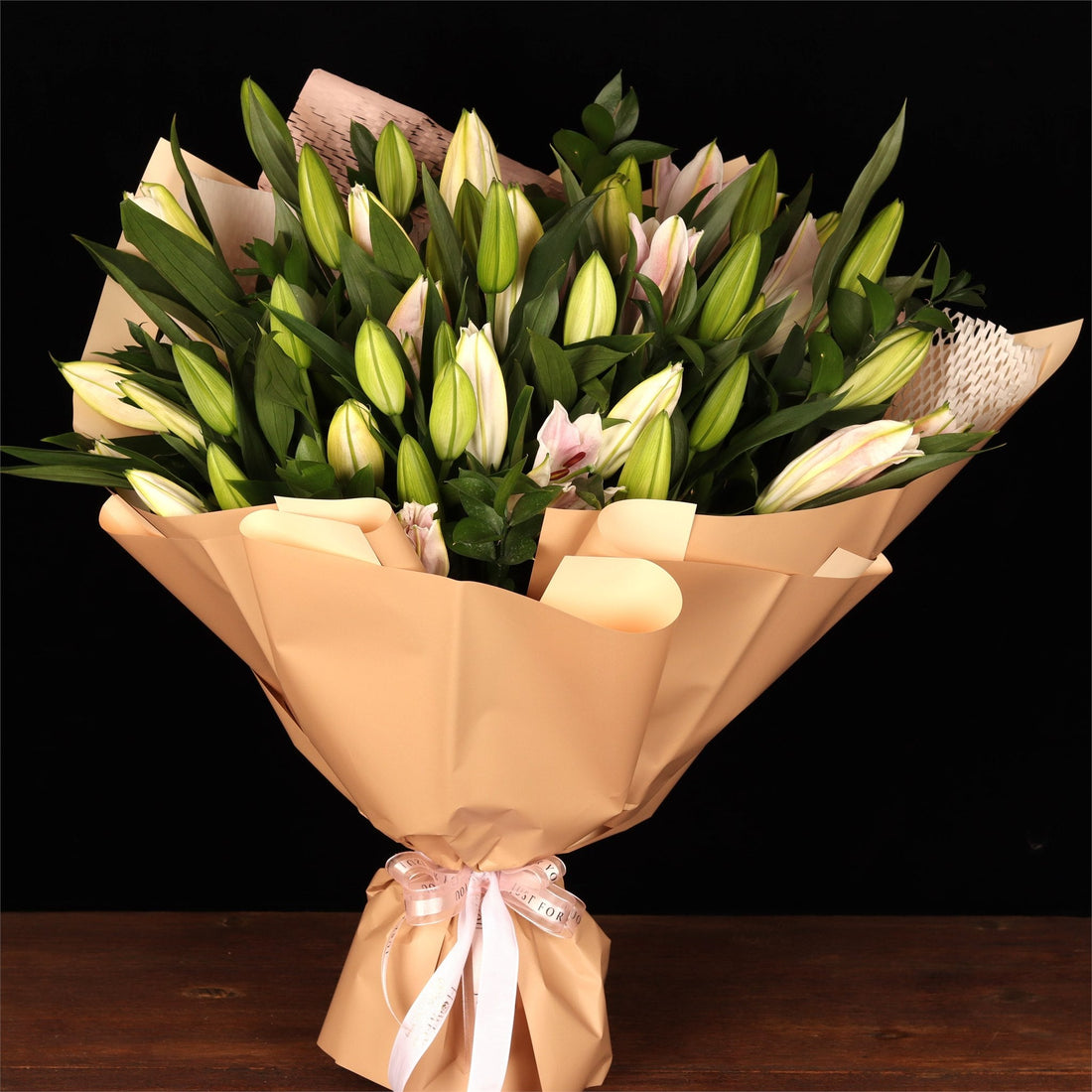 Bouquet of white lilies in kraft wrap, a formal and safe choice for gifting in the UAE