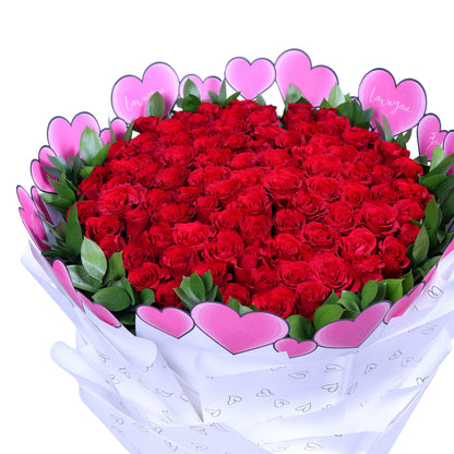 Make an unforgettable statement of love with the “Centennial Love” 100 Red Roses Bouquet, featuring 100 luxurious red roses paired with fresh ruscus leaves, elegantly wrapped in pristine white paper. Perfect for Valentine’s Day, anniversaries, weddings, or grand romantic gestures, this bouquet exudes sophistication, passion, and elegance. A truly magnificent gift that conveys love in its most breathtaking form.