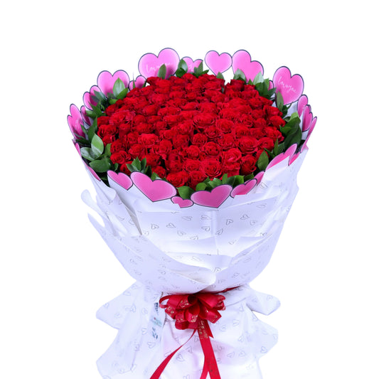 Make an unforgettable statement of love with the “Centennial Love” 100 Red Roses Bouquet, featuring 100 luxurious red roses paired with fresh ruscus leaves, elegantly wrapped in pristine white paper. Perfect for Valentine’s Day, anniversaries, weddings, or grand romantic gestures, this bouquet exudes sophistication, passion, and elegance. A truly magnificent gift that conveys love in its most breathtaking form.