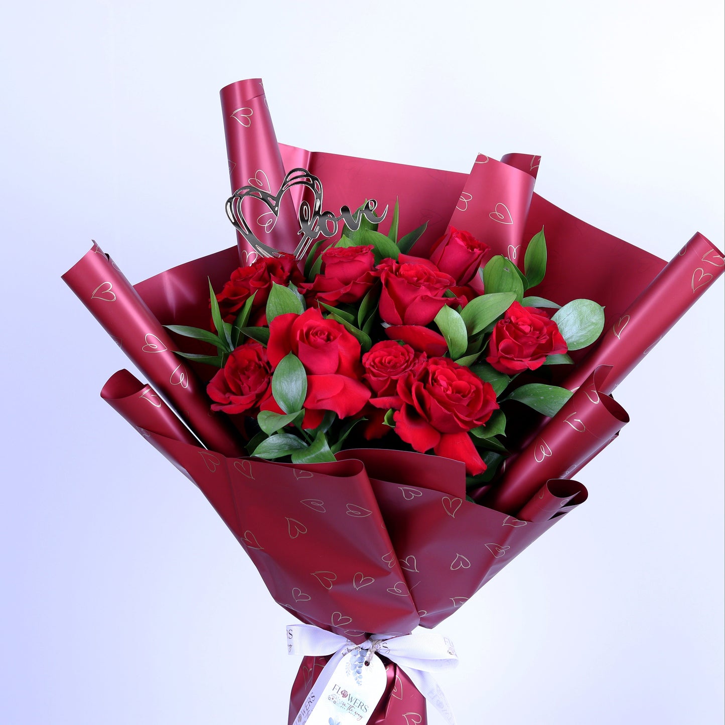 Express your love this Valentine’s Day with our elegant 10 Red Roses Bouquet, beautifully arranged with fresh ruscus leaves and a romantic acrylic heart, all wrapped in luxurious red wrapping. This classic Valentine’s bouquet is perfect for romantic surprises, anniversaries, and meaningful love gestures, making it an unforgettable gift that speaks from the heart.