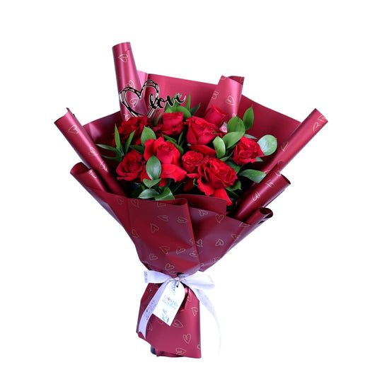 Express your love this Valentine’s Day with our elegant 10 Red Roses Bouquet, beautifully arranged with fresh ruscus leaves and a romantic acrylic heart, all wrapped in luxurious red wrapping. This classic Valentine’s bouquet is perfect for romantic surprises, anniversaries, and meaningful love gestures, making it an unforgettable gift that speaks from the heart.