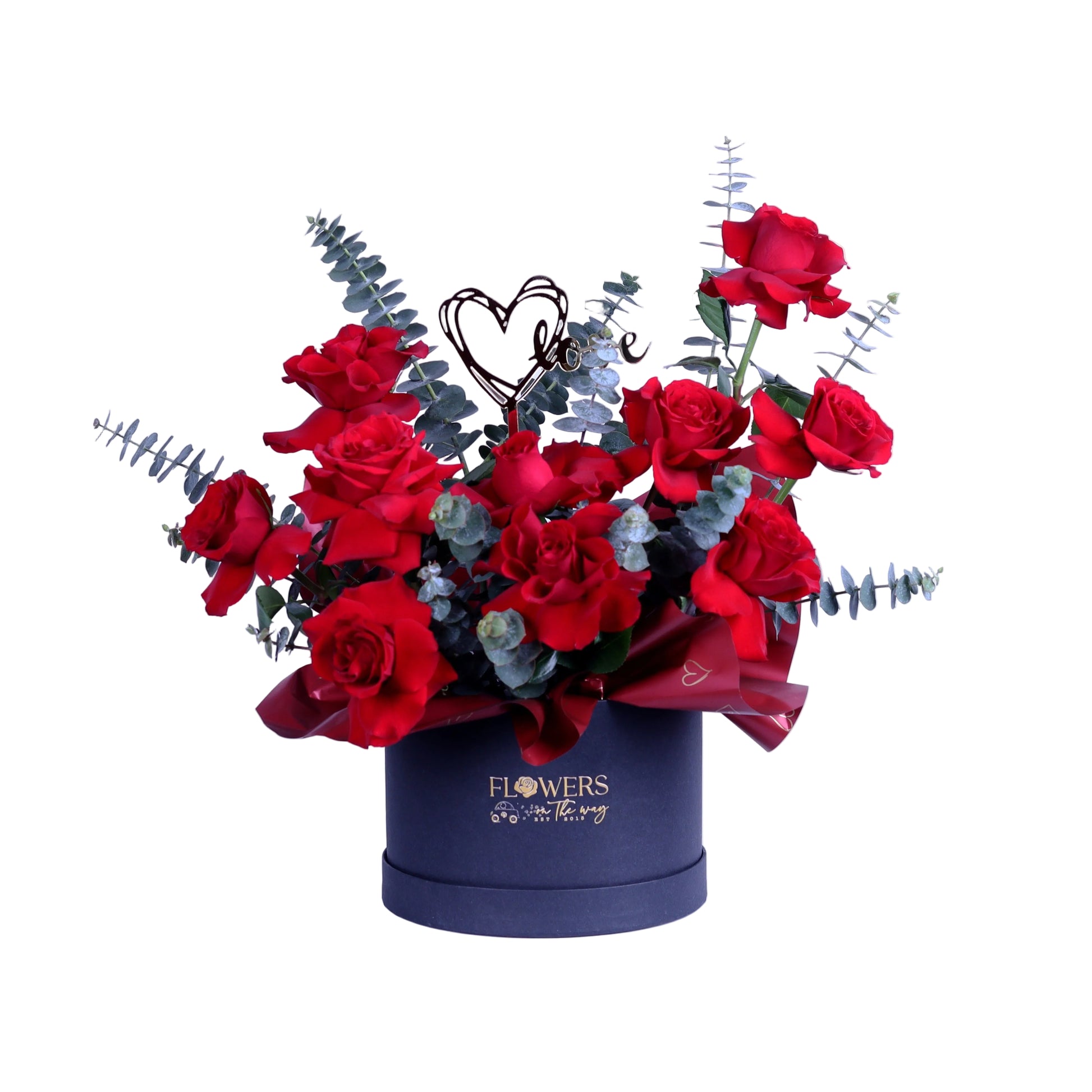 Create a lasting impression with this Romantic Red Roses Box, featuring premium red roses elegantly arranged with fresh eucalyptus leaves and finished with a stylish acrylic heart. Presented in a chic small round box, this arrangement is ideal for Valentine’s Day, anniversaries, and meaningful romantic surprises.