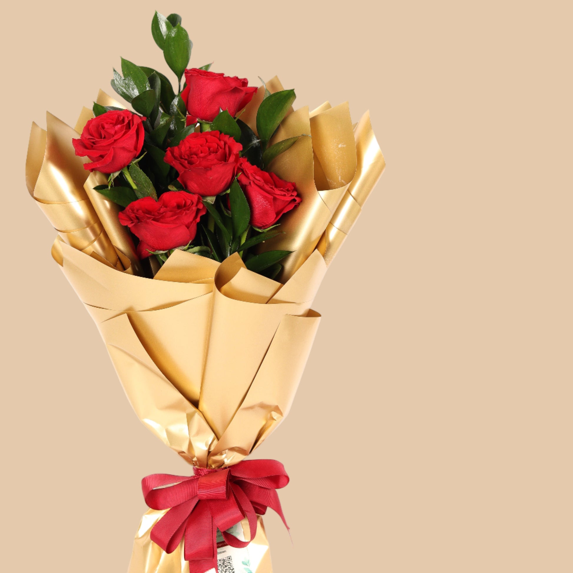 Elegant bouquet of 5 red roses wrapped in golden paper. A perfect romantic gift with fast delivery in Dubai.