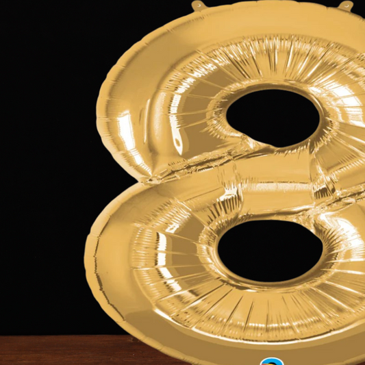 Close view of the giant gold number 8 foil balloon