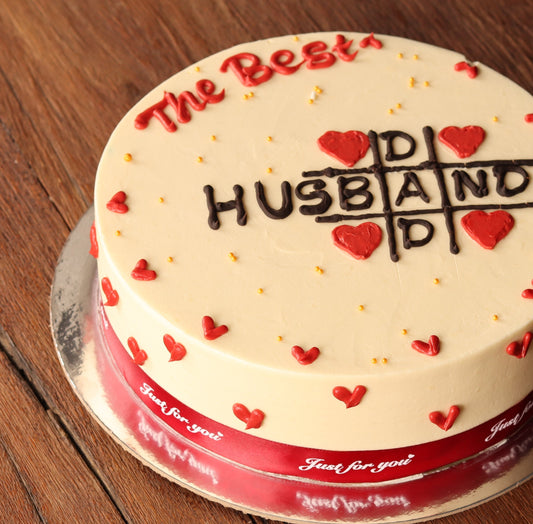 Cream cake reading The Best Husband decorated with red hearts