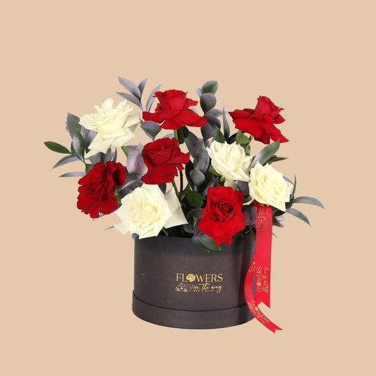 Elegant black box with a simple arrangement of white and red flowers. Perfect gift with fast Dubai delivery.
