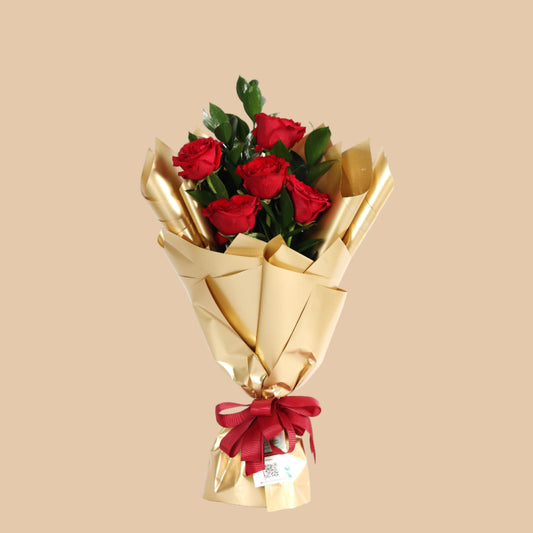 Elegant bouquet of 5 red roses wrapped in golden paper. A perfect romantic gift with fast delivery in Dubai.