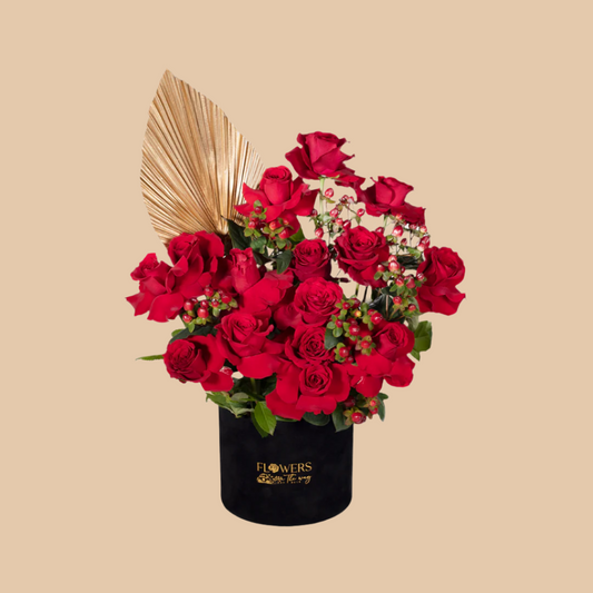 A design that blends luxury with deep romance — Royal Red Elegance Box features a luxurious black box filled with bold red roses and red hypericum, accented by elegant golden touches. The result is a majestic floral statement, perfect for romantic occasions, luxury gifts, or simply leaving a lasting impression. Available with fast flower delivery in Dubai.