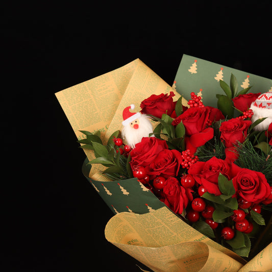 Chronicle Rose Bouquet - close-up of red roses, red berries and mini Santas, Christmas bouquet Dubai