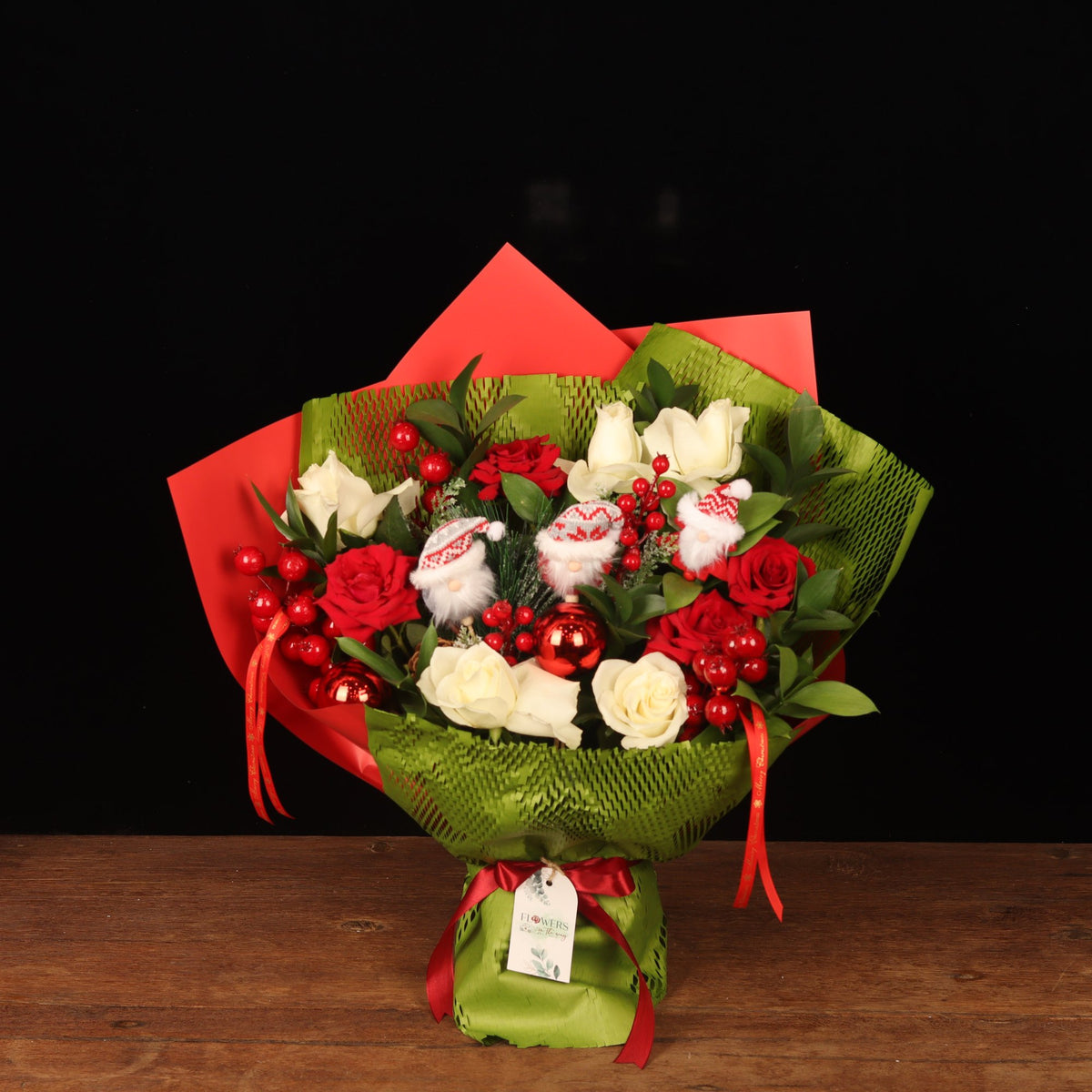 Crimson & Pine Holiday Bouquet - red and white roses Christmas bouquet with mini Santas in green and red wrapping, Christmas flower delivery Dubai