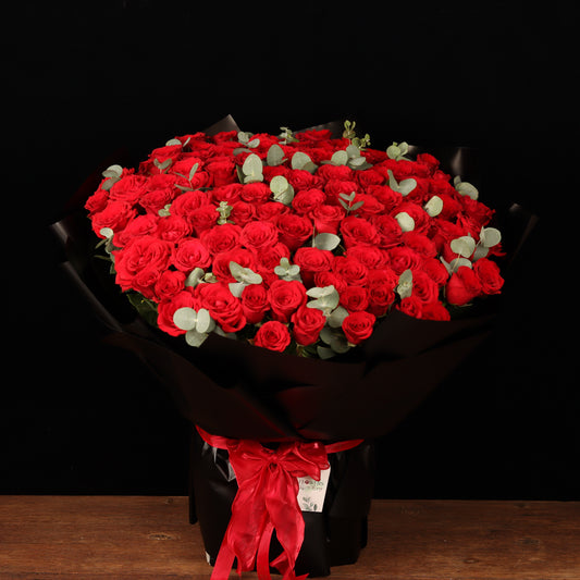 Passion Grand Bouquet – 100 red roses with eucalyptus in black wrapping, Valentine's Day flower delivery Dubai