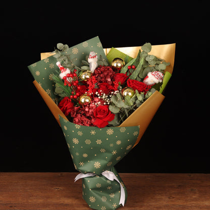 Golden Snowflake - red roses and crimson blooms Christmas bouquet in green snowflake wrapping with gold foil, Christmas flower delivery Dubai