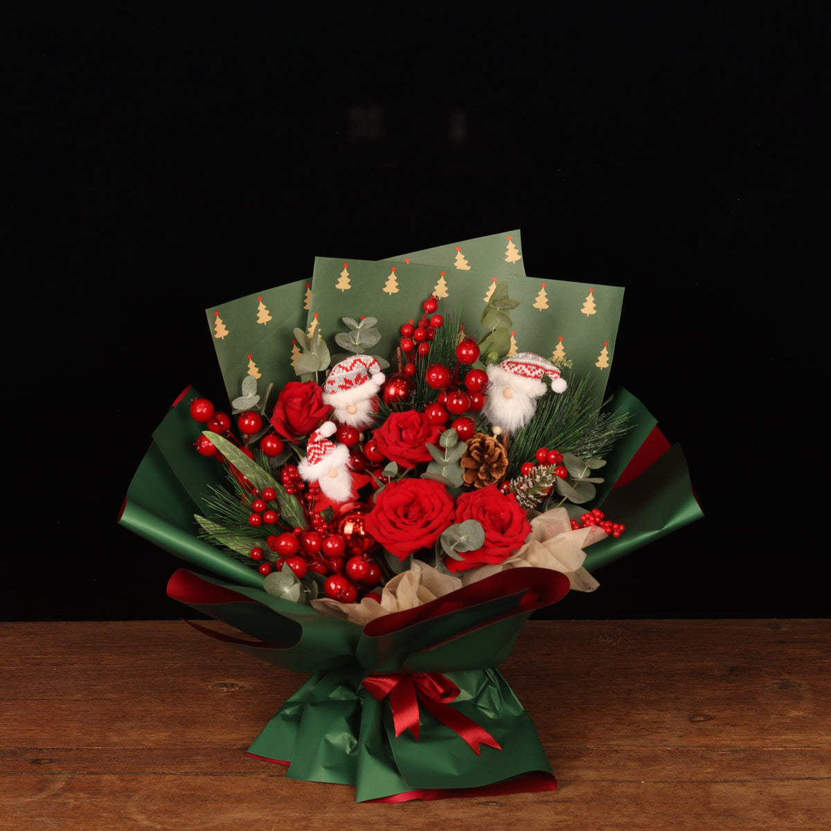 Holiday Cheer Bouquet - red roses, pine and red berries Christmas bouquet with mini Santas, Christmas flower delivery Dubai