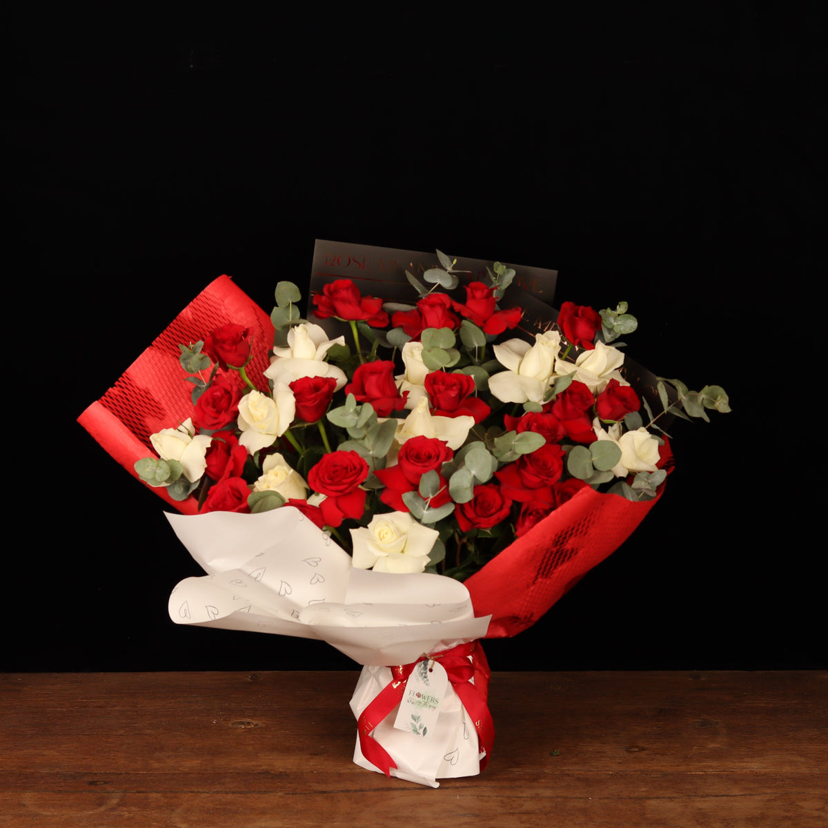 Hearts Entwined Bouquet – red and white roses with eucalyptus in red and white heart-print wrapping, Valentine's Day flower delivery Dubai