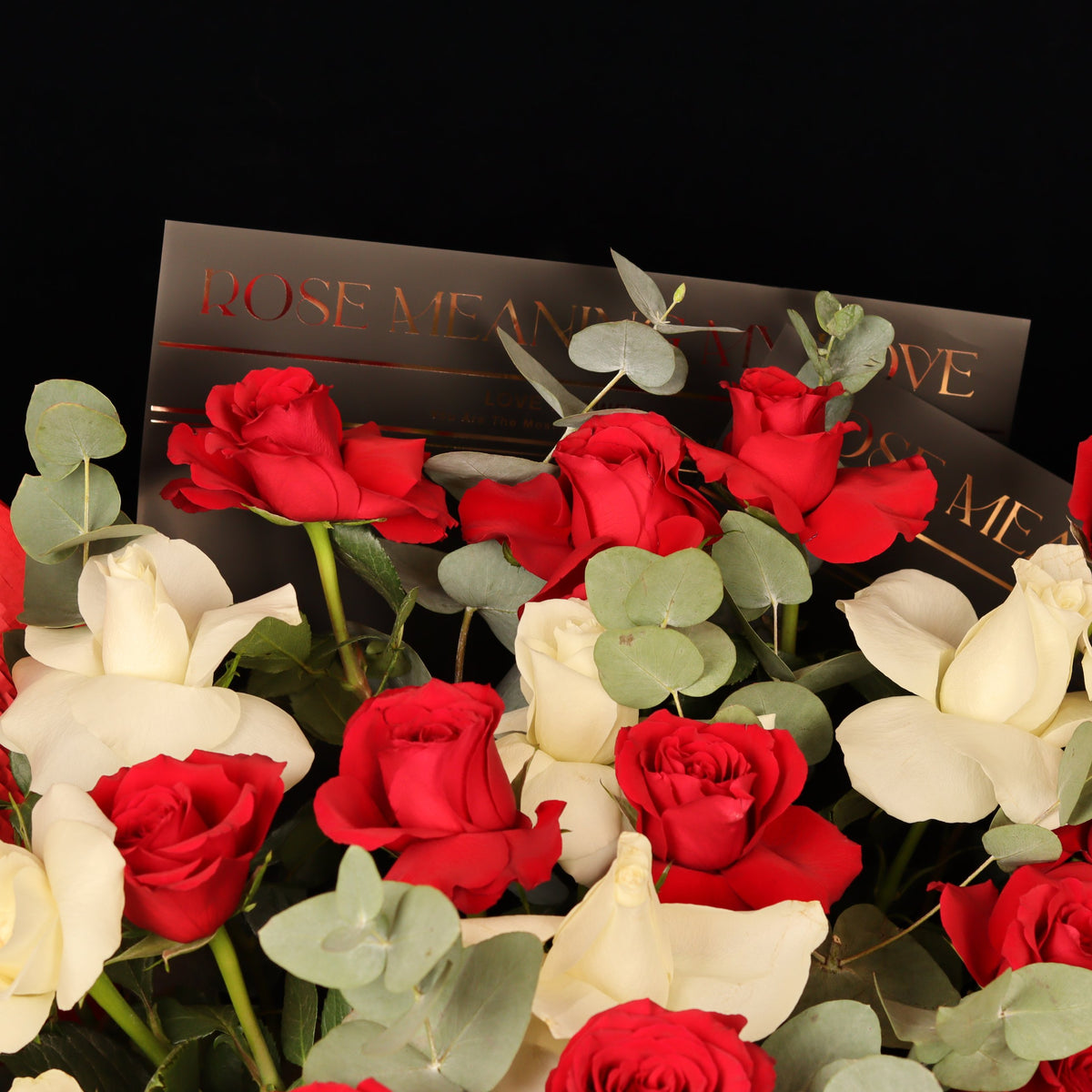 Hearts Entwined Bouquet – close-up of red and white roses with eucalyptus