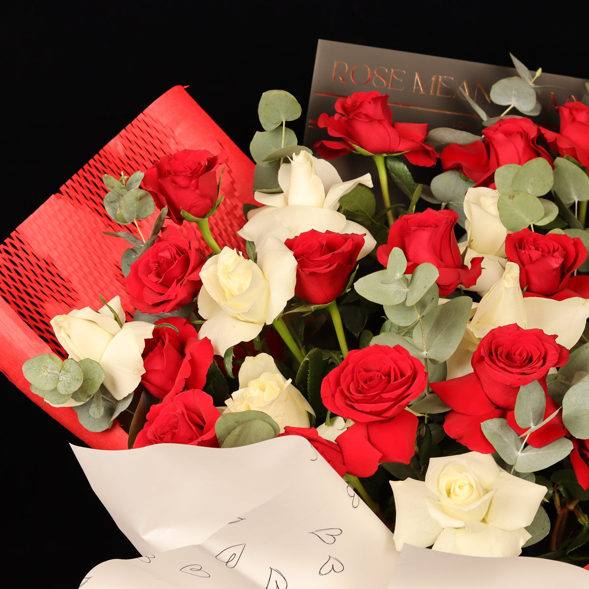 Hearts Entwined Bouquet – red and white roses in red honeycomb wrapping with gold-foil love sheets