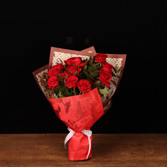 In the Name of Love Bouquet – 12 red roses with ruscus in vintage print and red honeycomb wrapping, Valentine's Day flower delivery Dubai