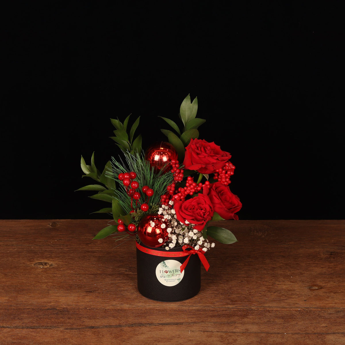 Winter Sparkle Mini - red roses, pine and red ornaments in a black round Christmas flower box, flower delivery Dubai