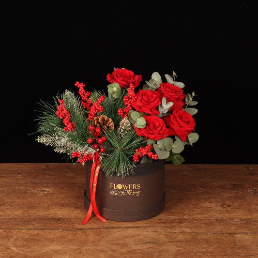 Winterberry Elegance Box - red roses, frosted pine and red berries in a brown round Christmas flower box, flower delivery Dubai