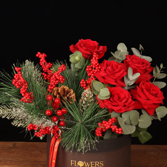 Winterberry Elegance Box - close-up of red roses, pine cones and red berries, Christmas flower box Dubai